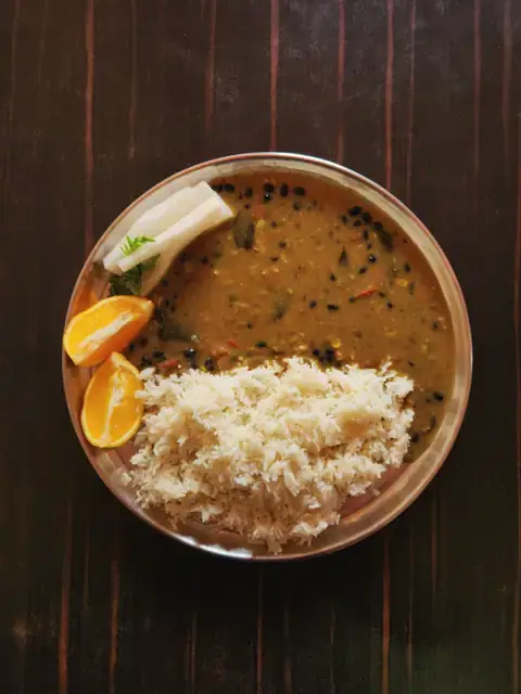 Dal and steamed rice on a steel plate, a typical weekday lunch